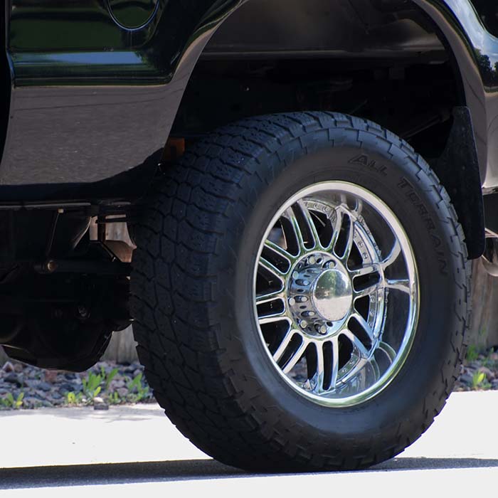 Rear axle and custom wheel and tire of a four wheel drive truck