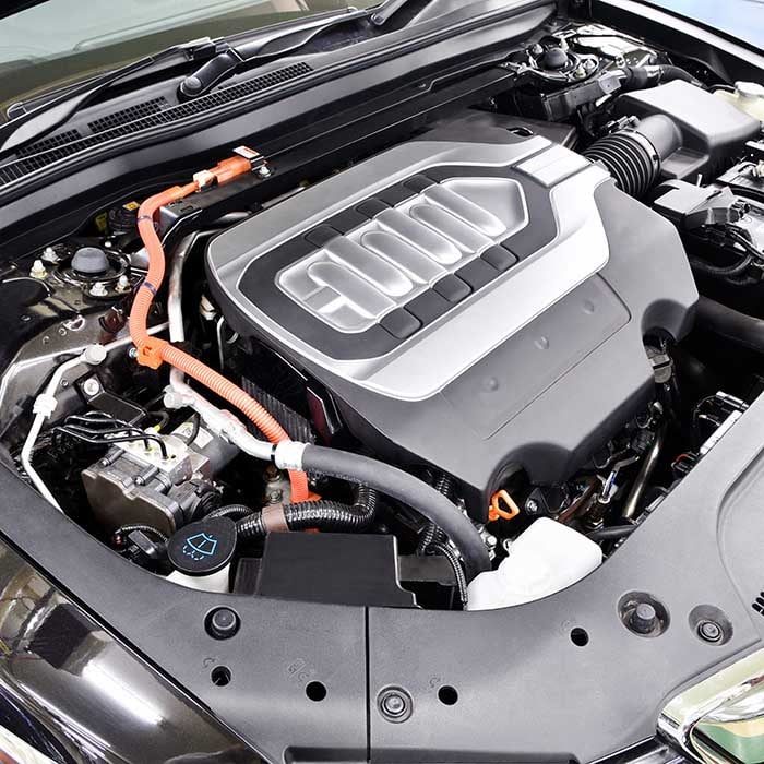 Specialist repairing a hybrid vehicle in an auto service center in Timonium, MD